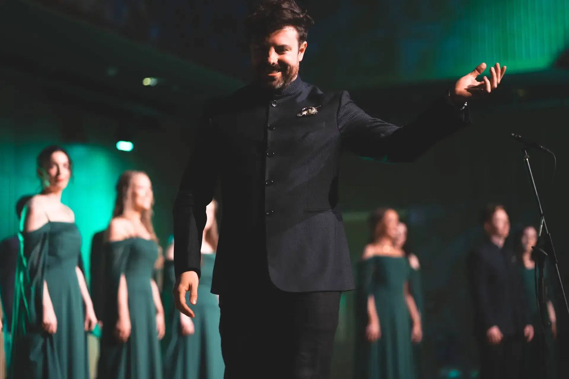 LORICA's conductor on stage in front of the choir