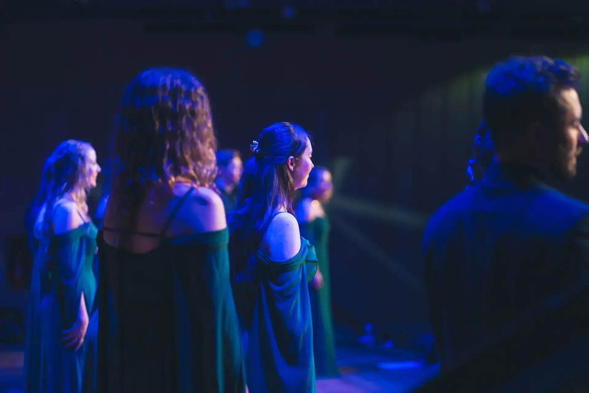 LORICA singers in profile under blue stage light