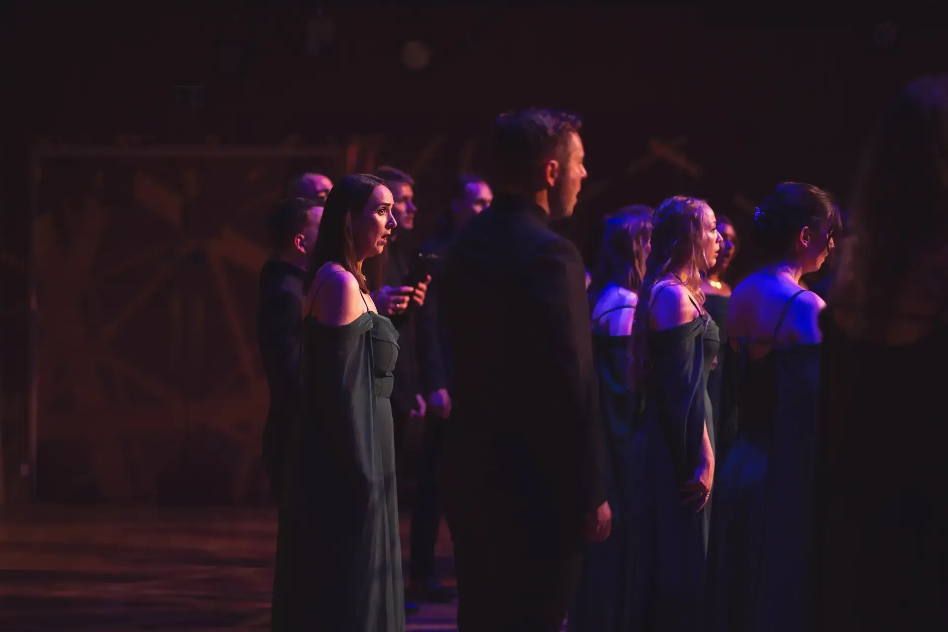 The choir singing in warm, low light